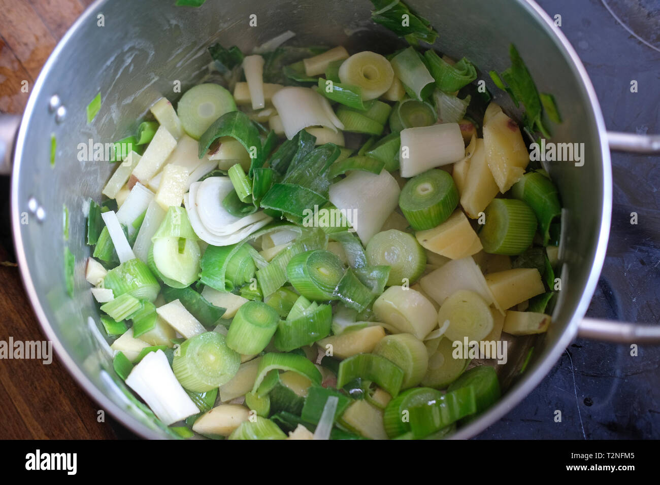 Potato and leeks cooking in a saucepan. Stock Photo