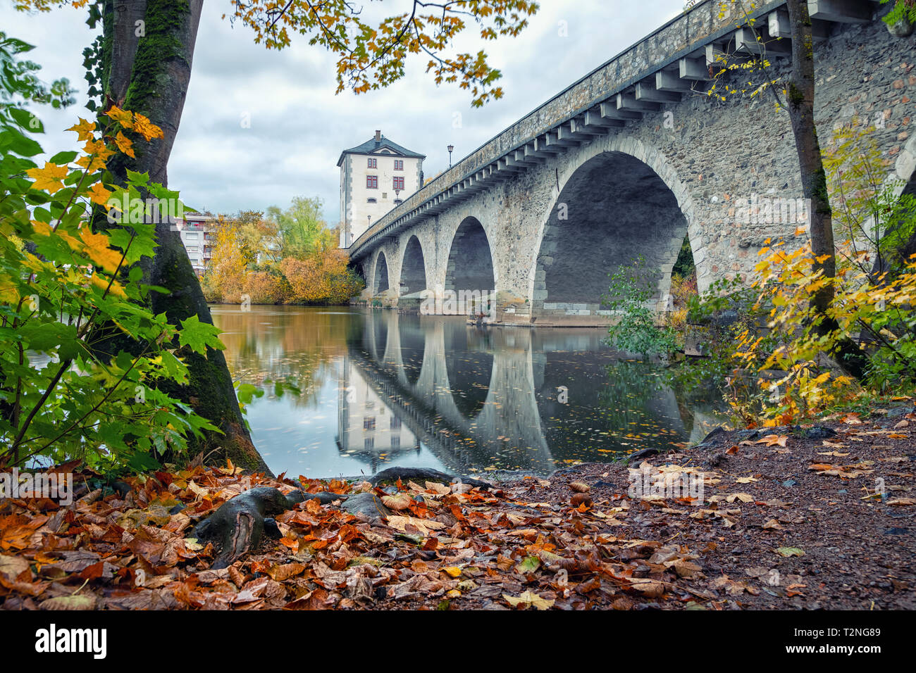 Limburg an der Lahn, Germany. View of Alte Lahnbrucke bridge reflecting in Lahn river in autum Stock Photo