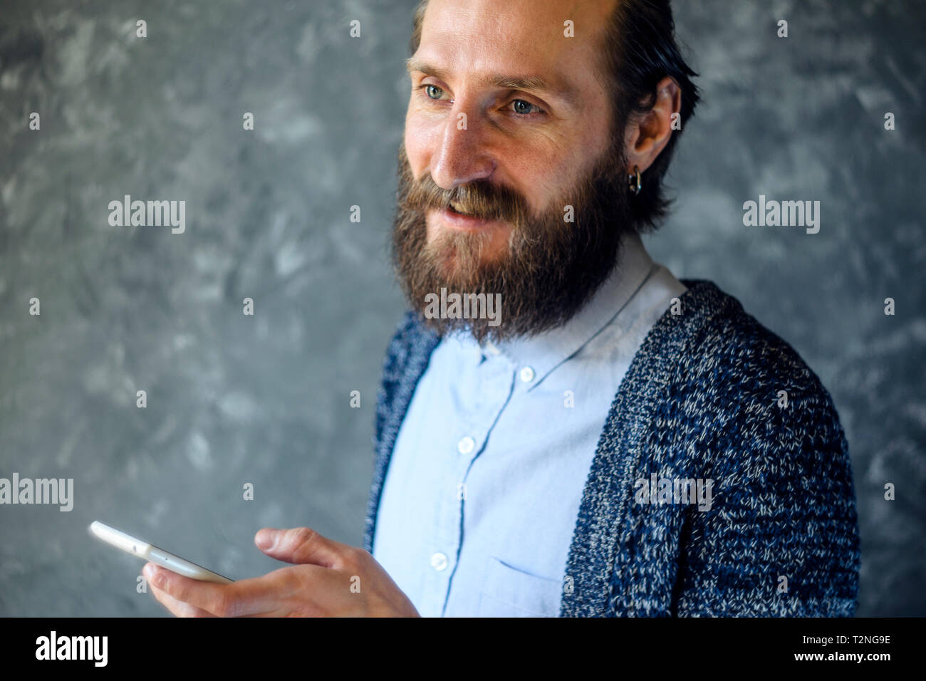 Bearded Man Have Business Meeting Via Video Call Against Gray Wall in a Office Stock Photo