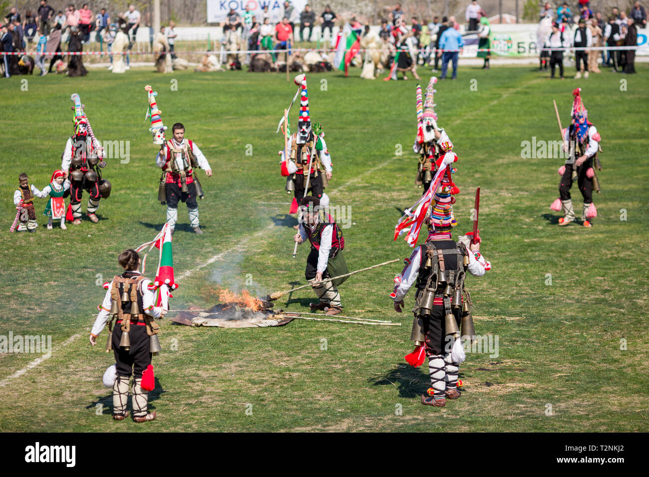 VARVARA, BULGARIA - MARCH 24, 2019: Moment from National Festival Dervish Varvara presents traditions of Bulgarian Kuker Games. Jumping over burning s Stock Photo