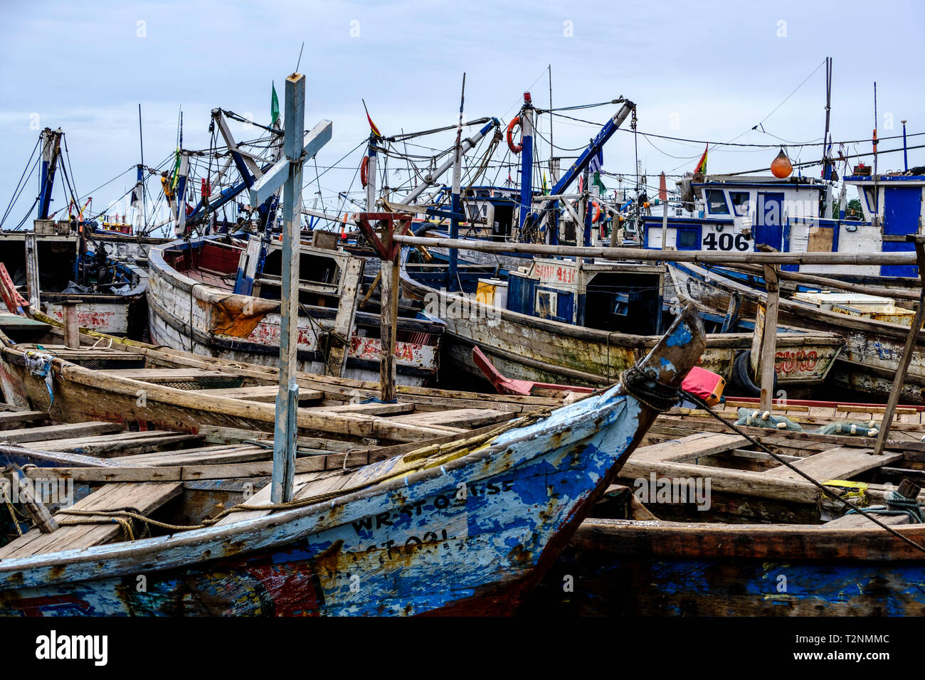 SEKONDI TAKORADI, GHANA – 10 APRIL 2018: The crush of colorful wooden fishing boats in busy Ghanaian harbor Stock Photo