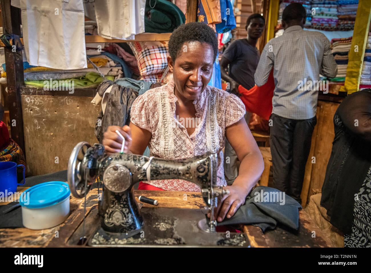 Seamstress working sewing machine , Kimironko Market , Kigali Rwanda