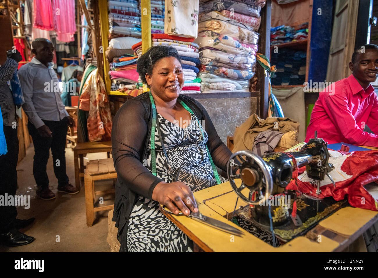 Seamstress working sewing machine , Kimironko Market , Kigali Rwanda