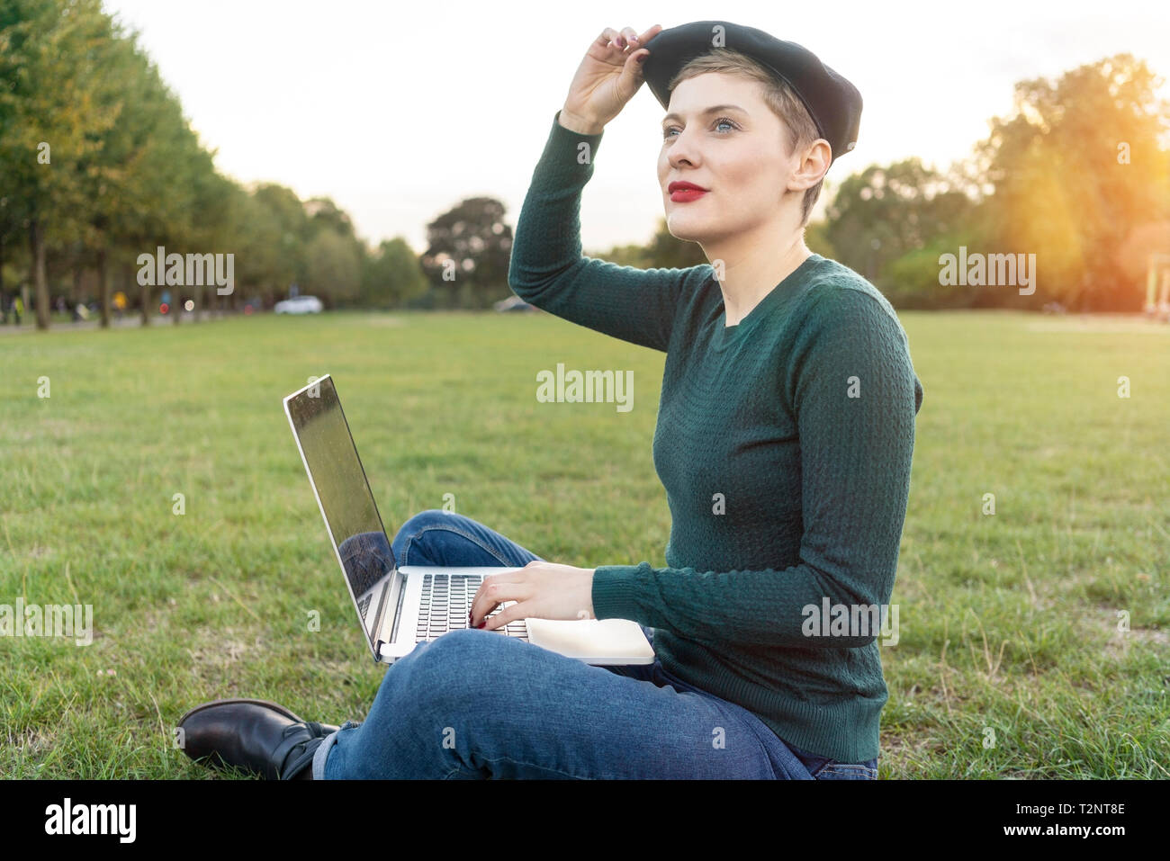 Woman using laptop in park Stock Photo