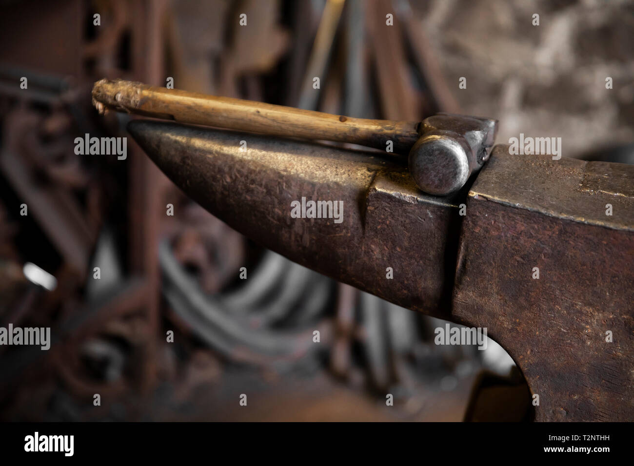 Hammer on top of anvil in blacksmiths workshop Stock Photo