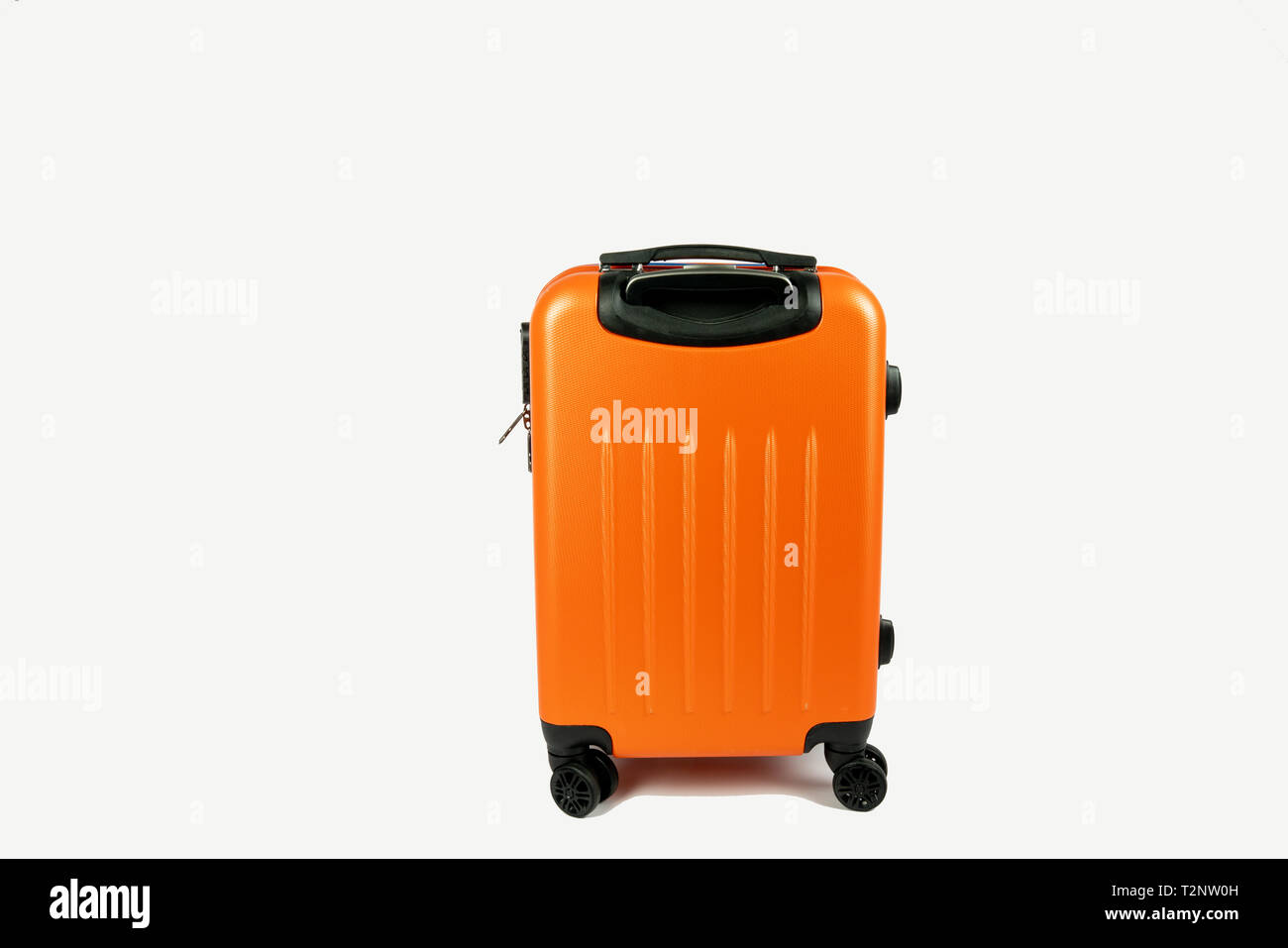 modern orange suitcase. Ready to go for your vacation or business trip. The suitcase is on a white background with space next to it for your own text. Stock Photo