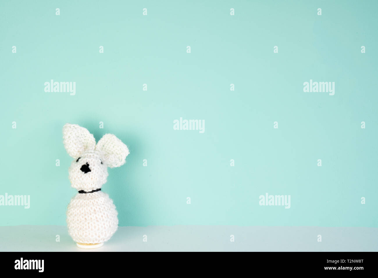 stuffed bunny toy in front of an colored background, with space next to it Stock Photo