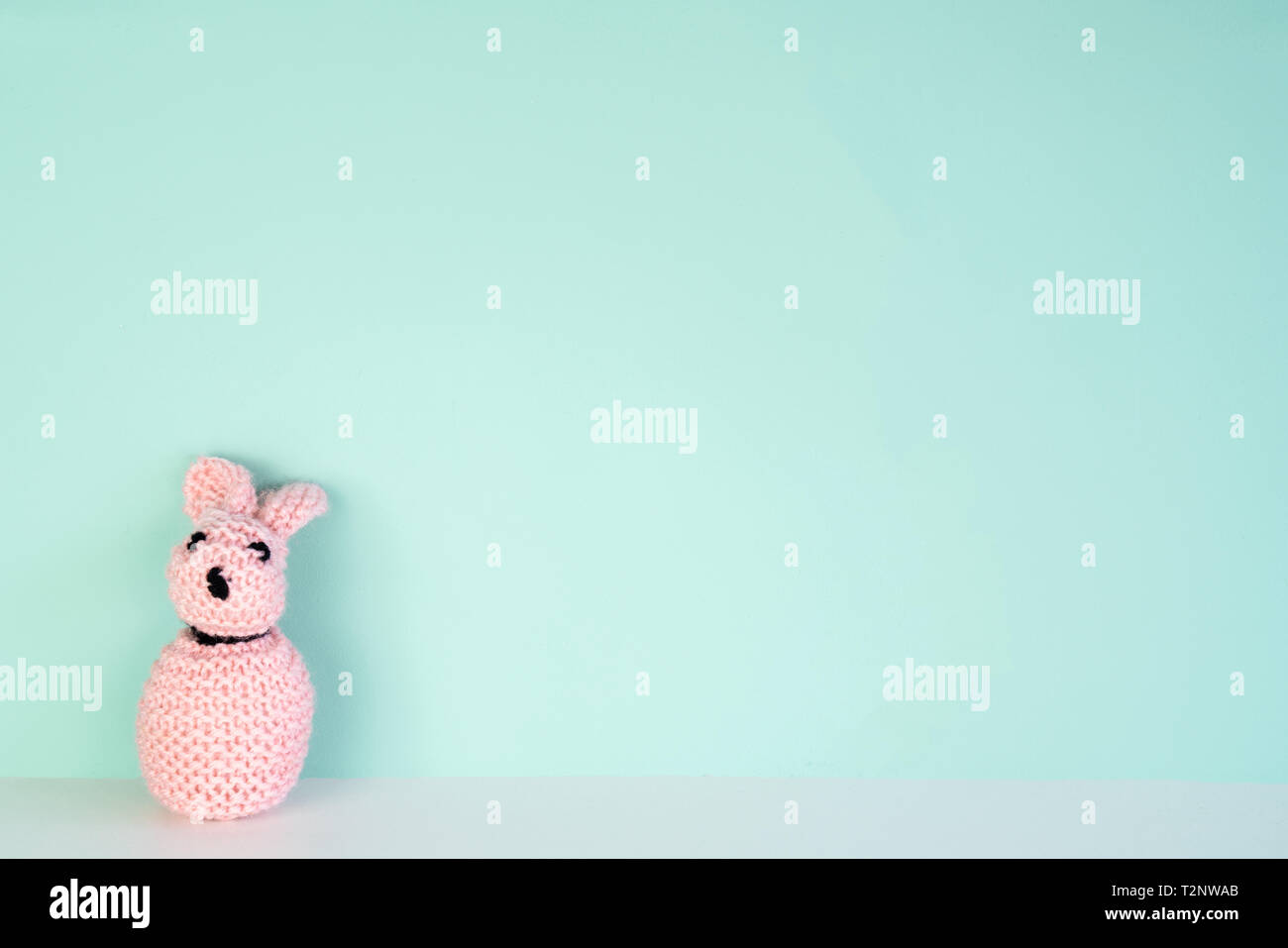stuffed bunny toy in front of an colored background, with space next to it Stock Photo