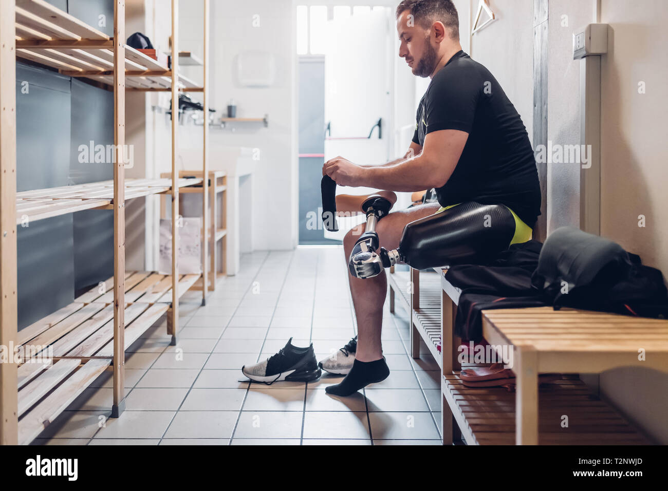 Man with prosthetic leg in gym changing room Stock Photo