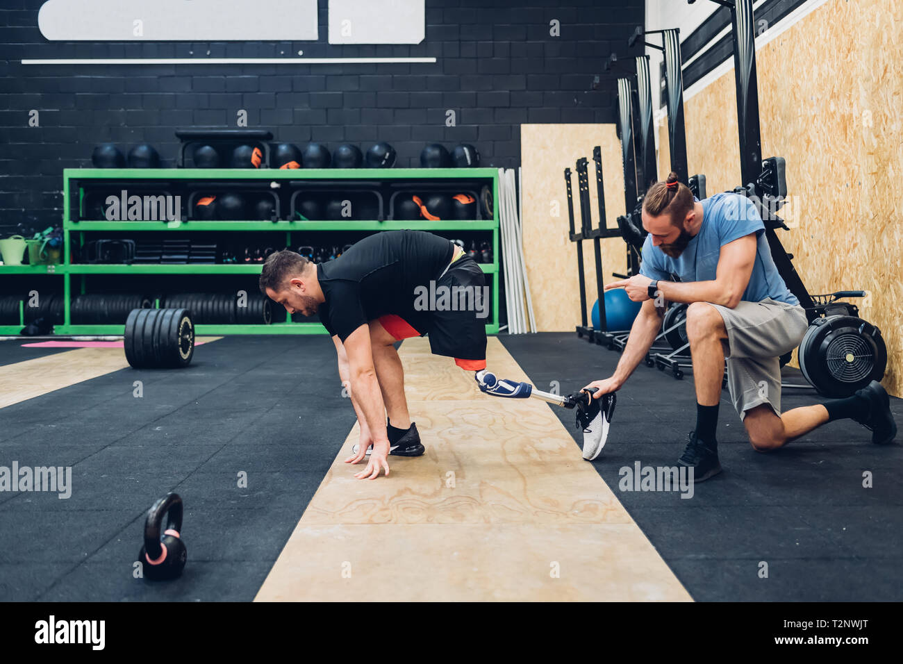Man with prosthetic leg training in gym Stock Photo