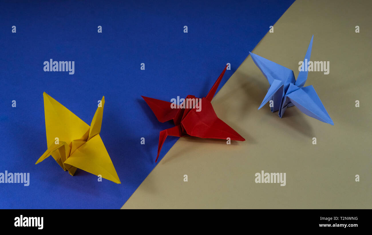 Japanese Origami Origami Crane Is A Symbol Of Peace Three Cranes On Blue And Yellow Background Stock Photo Alamy Japanese Origami Origami Crane Is A Symbol Of Peace Three Cranes On Blue And Yellow Background Stock Photo Alamy