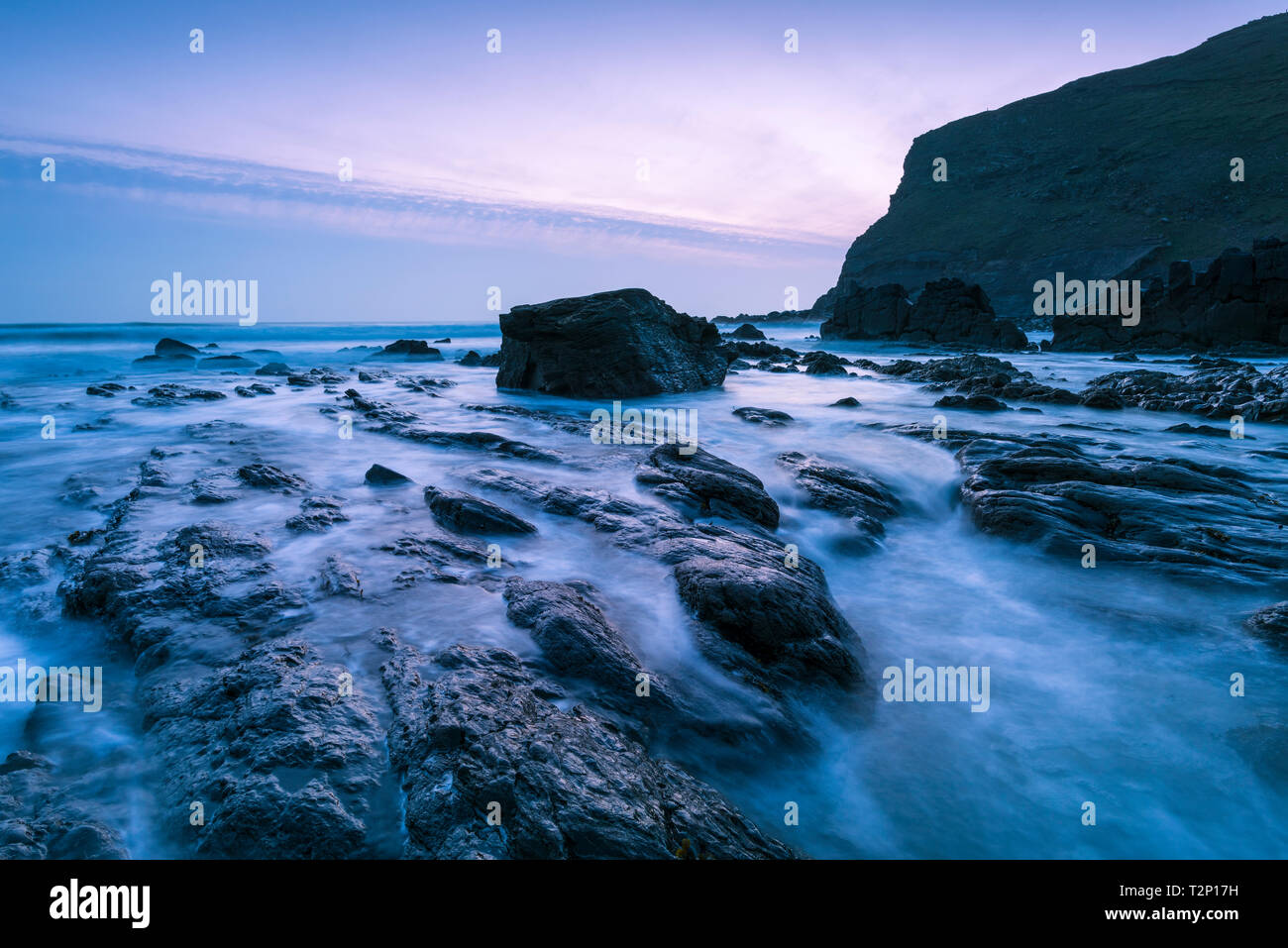 Rocks exposed by the retreating tide at Duckpool on the Hartland Heritage Coast, North Cornwall, England. Stock Photo
