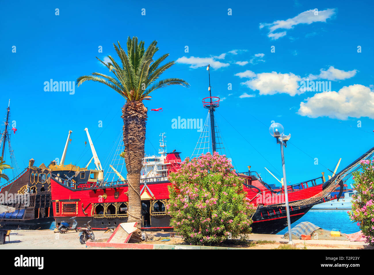 Landscape with old ships for excursions on city embankment in Sousse. Tunisia, North Africa Stock Photo