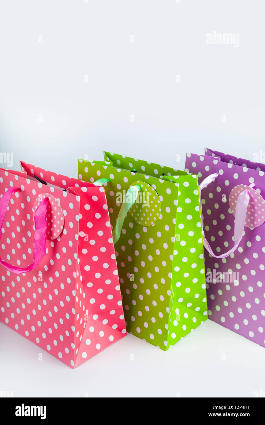 Three multi-colored shopping bags close-up. Stock Photo