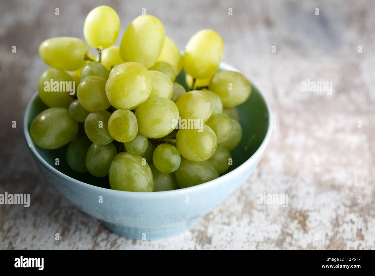 Wine Grapes in blue bowl Stock Photo