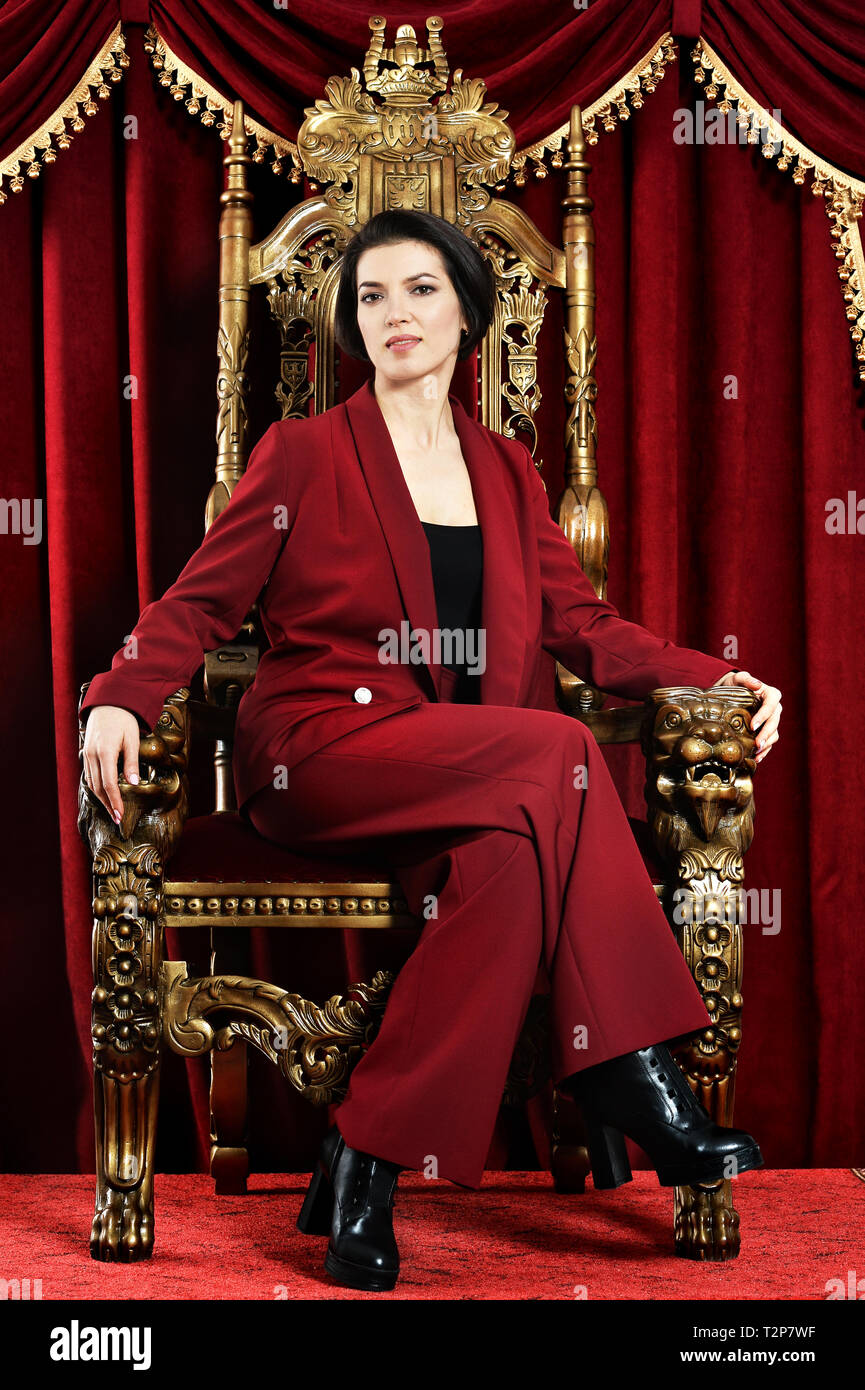 Portrait of beautiful young woman sitting in vintage chair Stock Photo ...