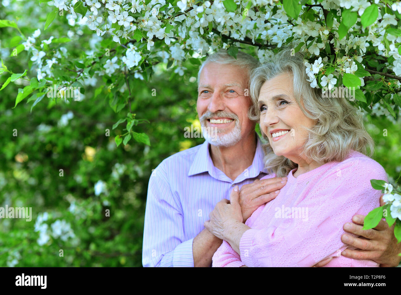 Happy lovely couple hugging in spring garden Stock Photo - Alamy