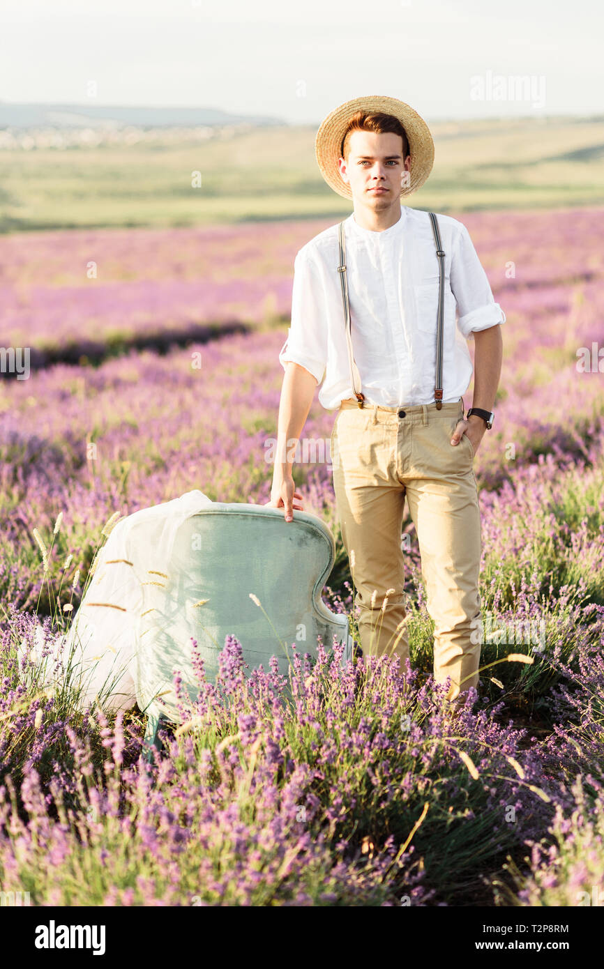 Stuning portrait of farmer in lavender field on golden sunset Stock Photo