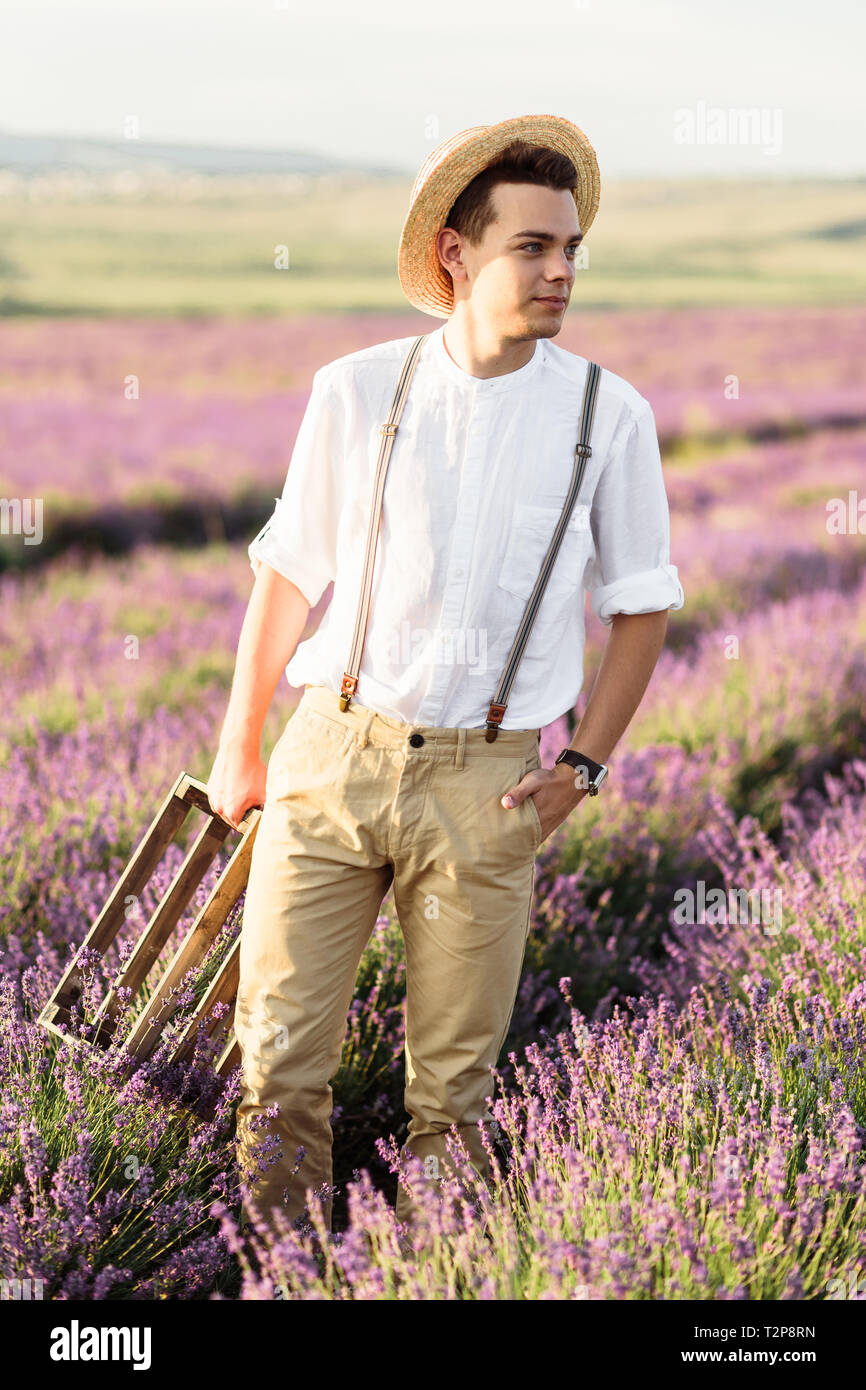 Stuning portrait of farmer in lavender field on golden sunset Stock Photo