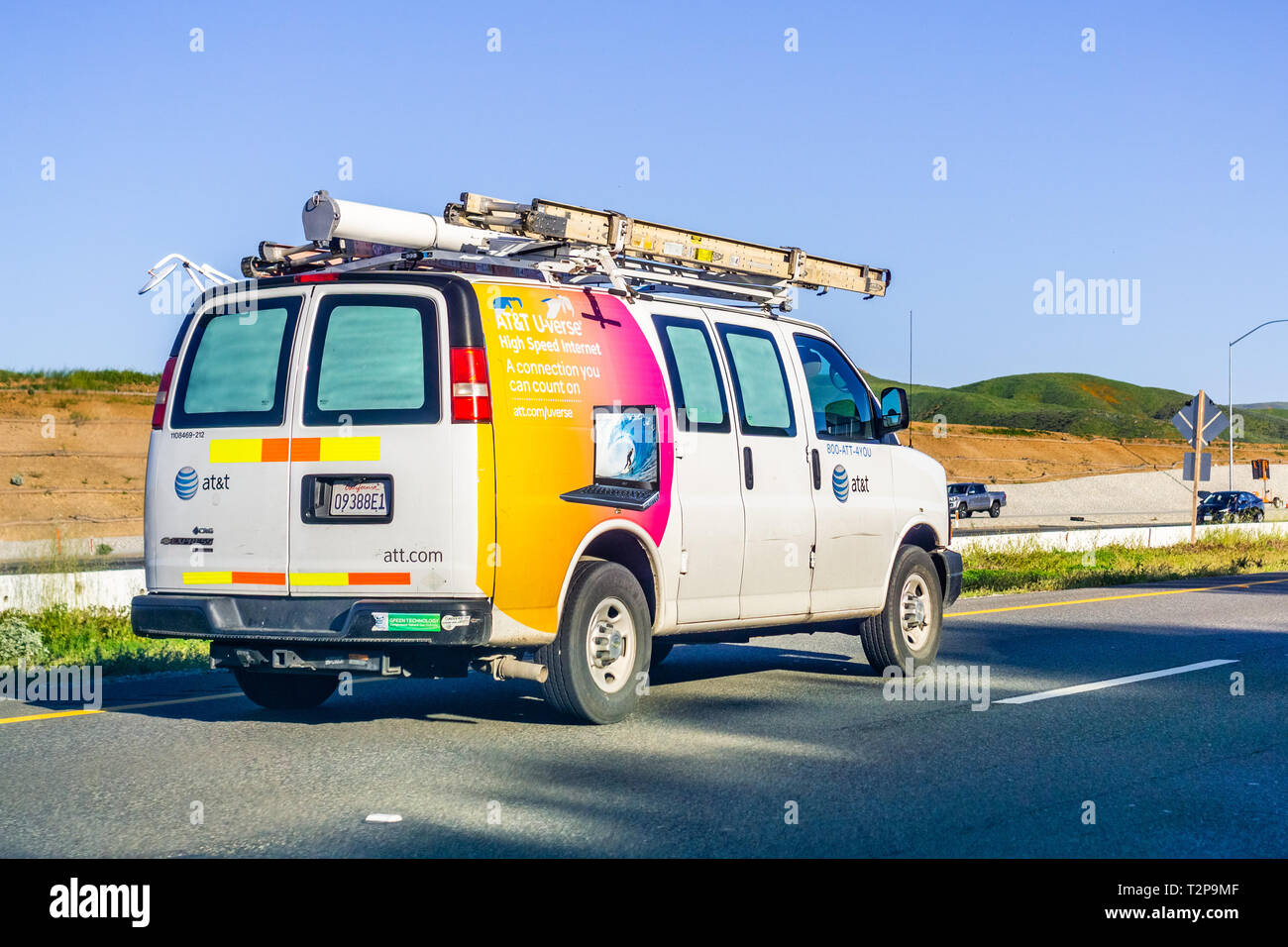 March 16, 2019 Los Angeles / CA / USA - AT&T service vans driving on the freeway; emblem displayed on the side Stock Photo