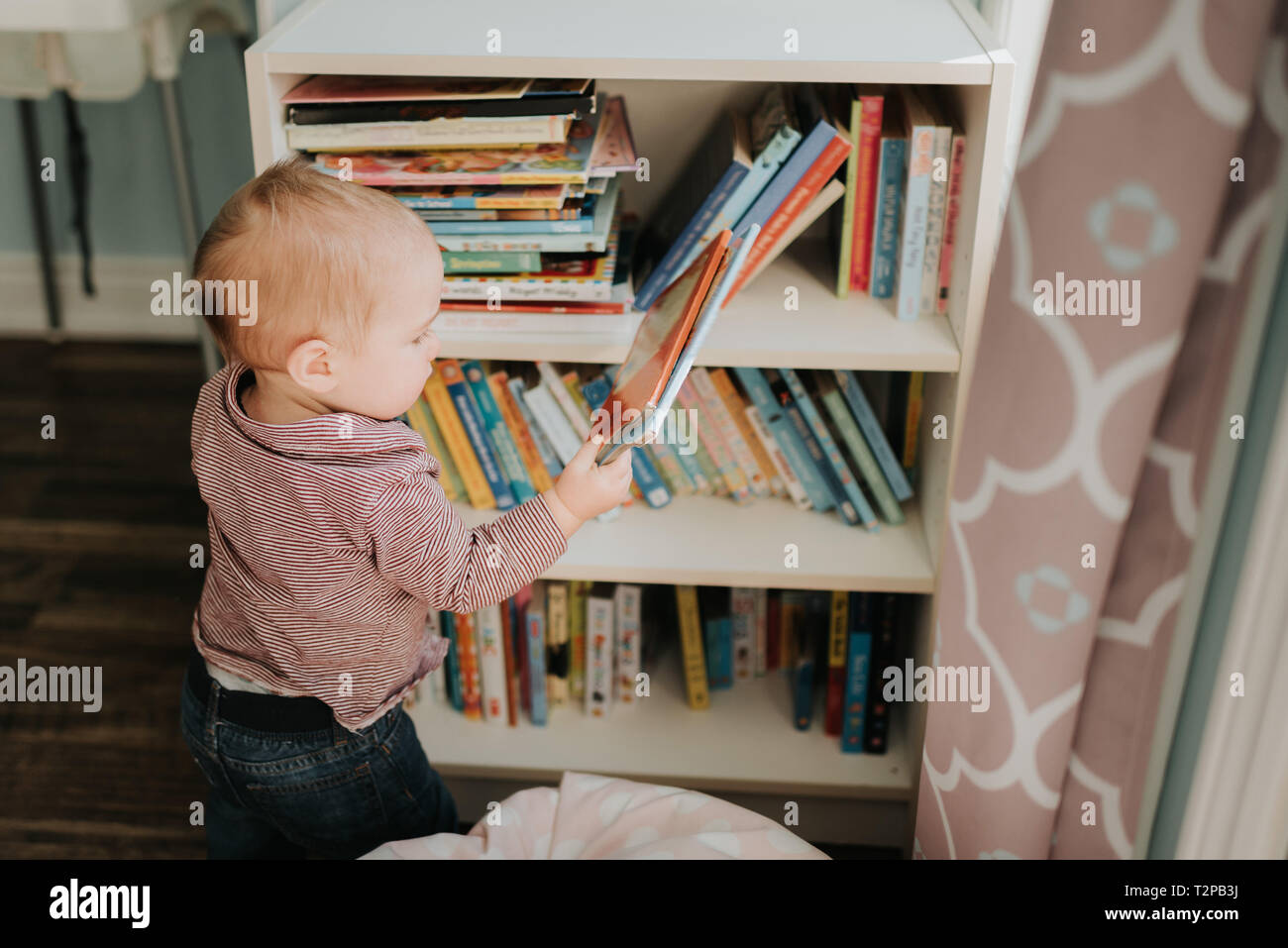 Boy Choosing Book From Bookshelf Stock Photos Boy Choosing Book