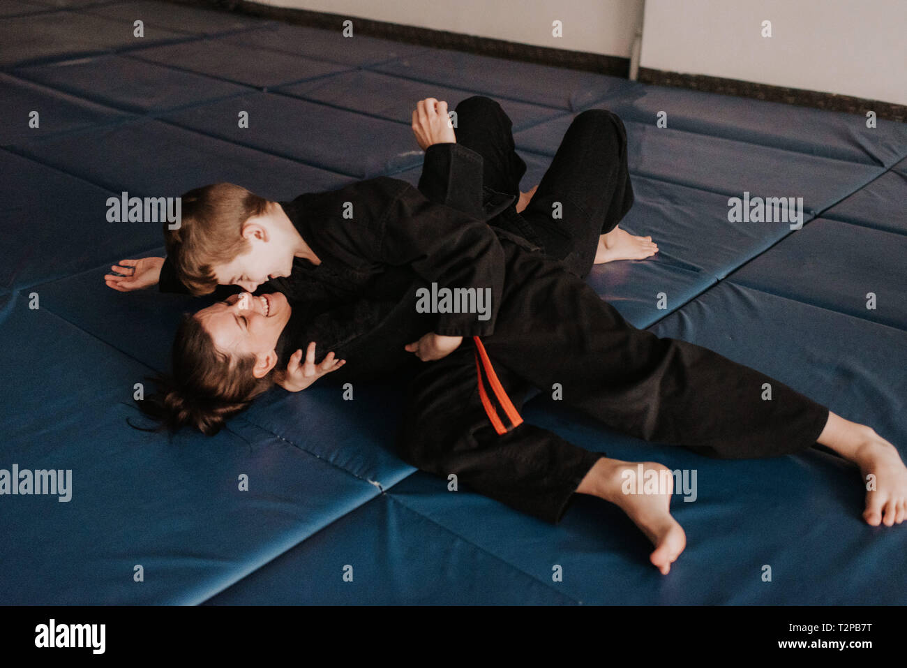 Coach and student wrestling in studio Stock Photo