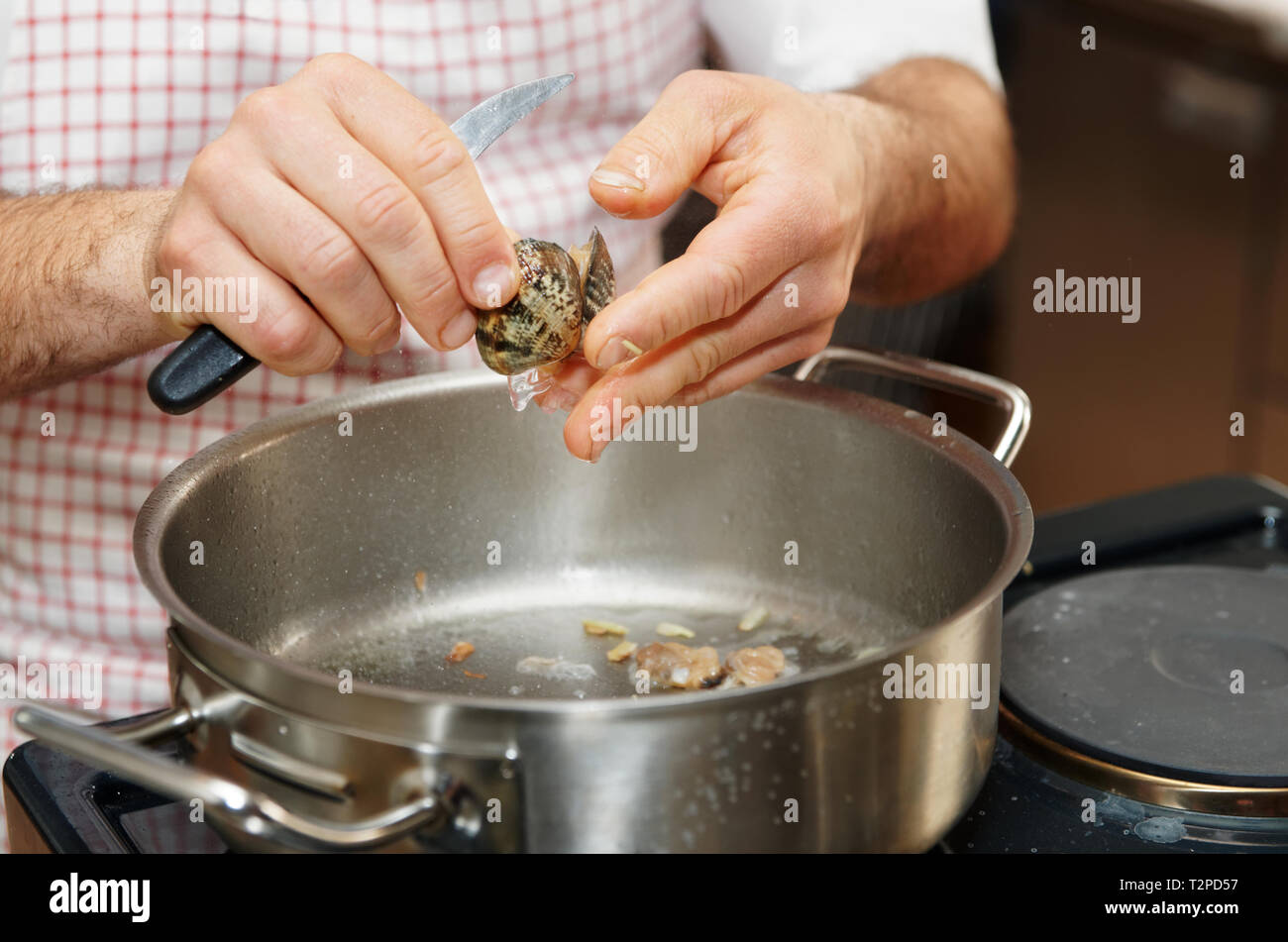Chef is peeling clams to make seafood broth Stock Photo Alamy