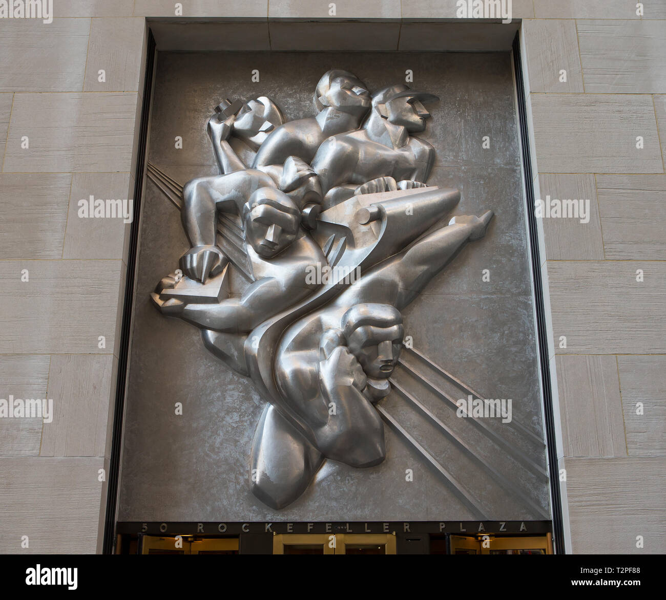 Isamu Noguchi's 10-short-ton (8.9-long-ton) stainless steel panel, News, located above the entrance to 50 Rockefeller Plaza (formerly the Associated P Stock Photo