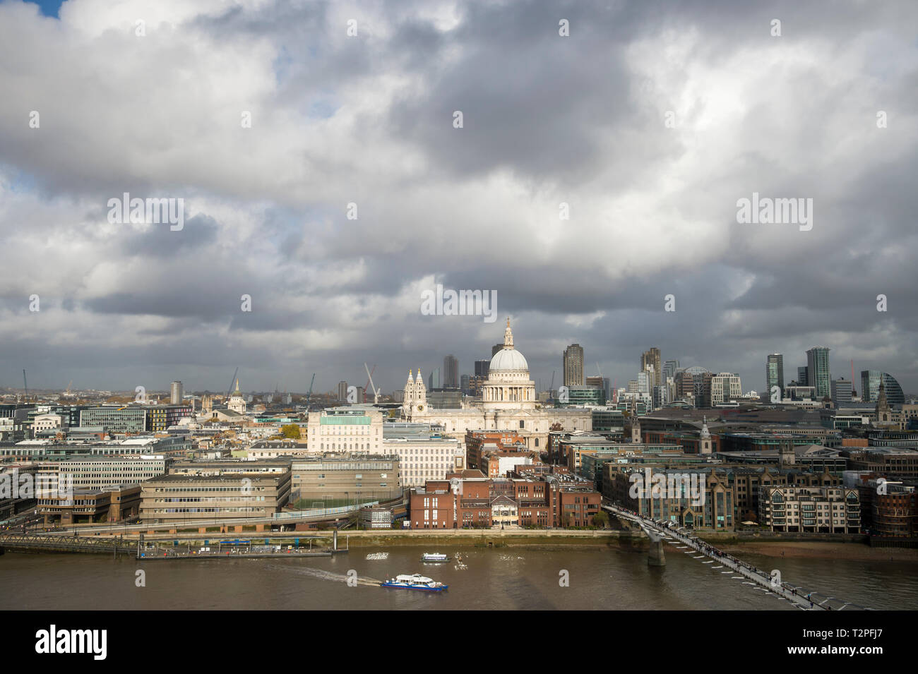 Scenic overcast view of the city skyline with a patch of sun lighting
