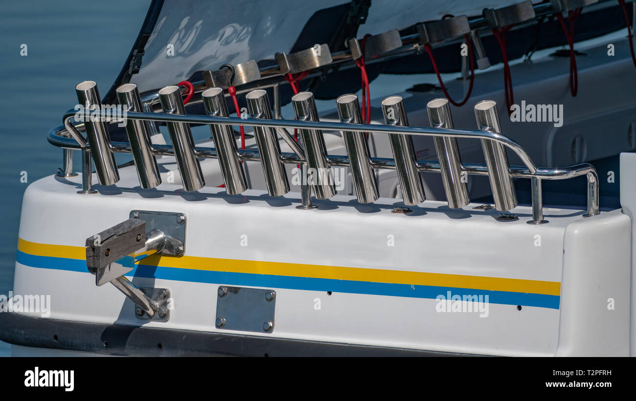 A bullbar of stainless steel fishing rod holders on the stern of a