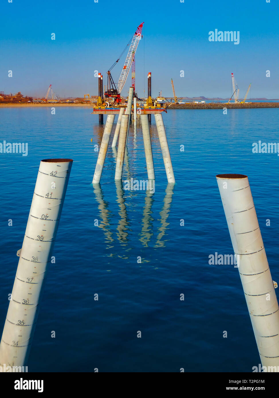 The construction of a wharf in full flow with raked piles in place ready for headstocks Stock Photo