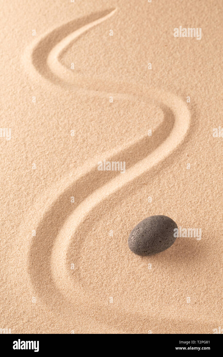Zen stone Japanese meditation sand garden for focus and concentration on balance and spirituality. Yoga or spa wellness sandy background with round ro Stock Photo