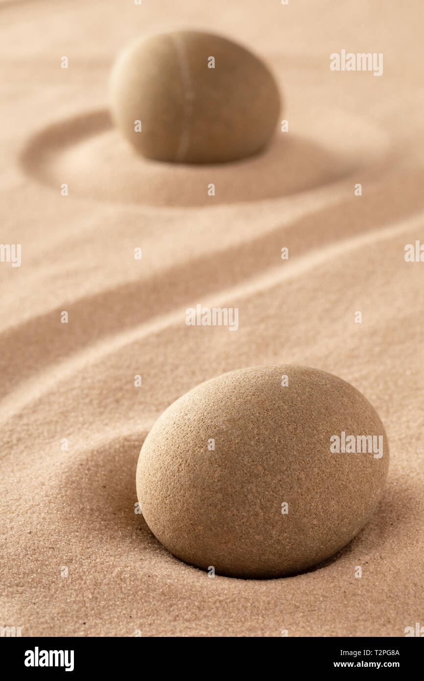 two round stones in sand. Japanese rock garden stands for purity and harmony. Stock Photo