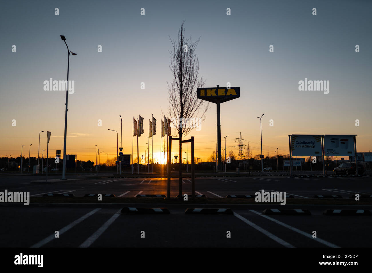 RIGA, LATVIA - APRIL 3, 2019: IKEA brand sign during dark evening and wind - Blue sky in the background - Popular shopping centre Stock Photo