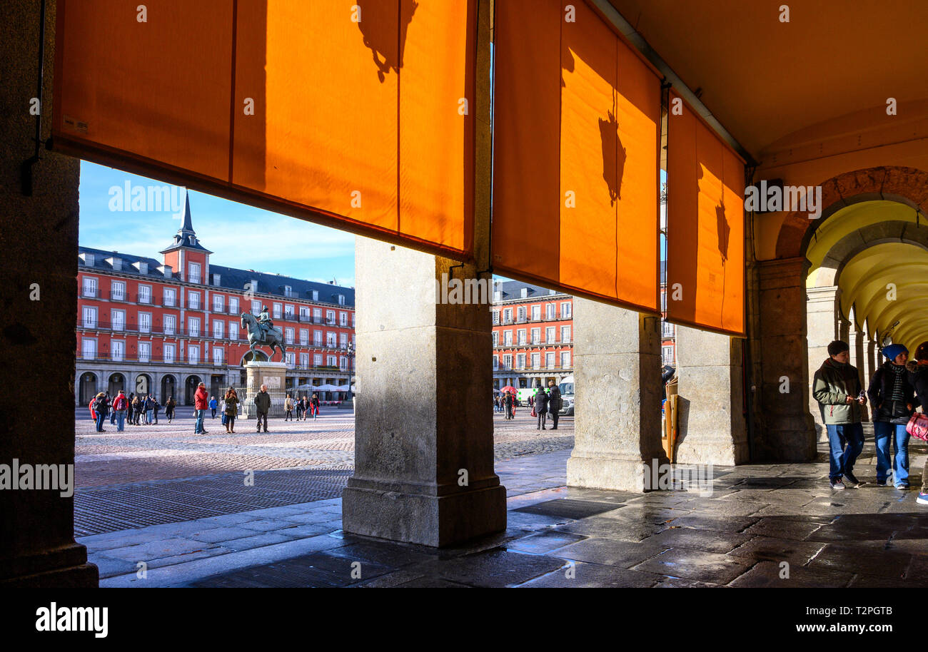 In the shade of the arches in the Plaza Mayor in the centre of Madrid, Spain Stock Photo