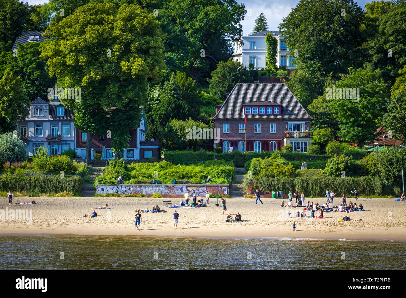 Hamburg, Germany - June 25, 2014: Summer view of the beach (Strand Oevelgoenne) on the Elbe river in Oevelgoenne district of Hamburg city. Popular pla Stock Photo