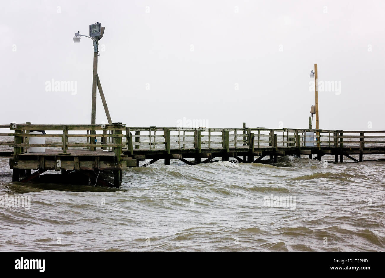 Waves from Tropical Storm Cindy lap beneath Cedar Point Pier, June 22, 2017, in Coden, Alabama. Stock Photo