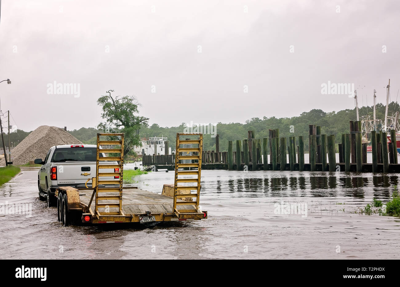 A truck makes its way down a flooded Shell Belt Road after Tropical Storm Cindy, June 22, 2017, in Bayou La Batre, Alabama. Stock Photo