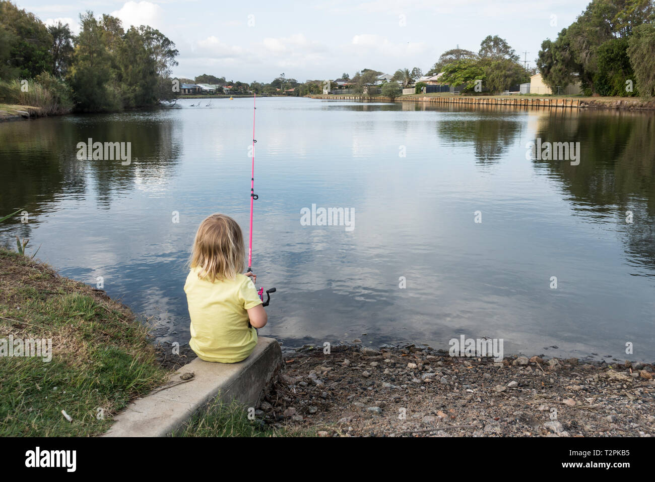 Four year old girl fishing at a local pond. Beachmere Queensland Australia. Stock Photo