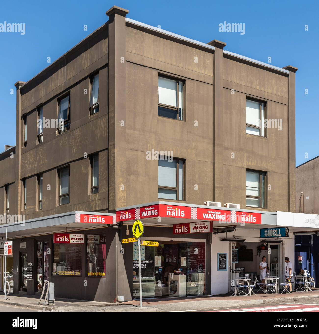 Sydney, Australia - February 11, 2019: Nails and waxing salon on corner of Gould and Curlewes street in Bondi Beach. White on red advertisements, disp Stock Photo