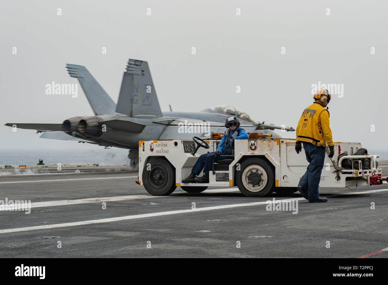 U.S. Sailors prepare to taxi aircraft as an F/A-18F Super Hornet, assigned to Strike Fighter Squadron (VFA) 41, launches from the flight deck of the aircraft carrier USS John C. Stennis (CVN 74) in the Arabian Gulf, April 1, 2019. The John C. Stennis Carrier Strike Group is deployed to the U.S. 5th Fleet area of operations in support of naval operations to ensure maritime stability and security in the Central Region, connecting the Mediterranean and the Pacific through the western Indian Ocean and three strategic choke points. (U.S. Navy photo by Mass Communication Specialist Seaman Jeffery L. Stock Photo