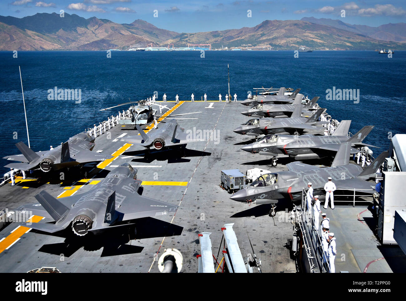 190402-N-RI884-0096 SUBIC BAY, Philippines (April 2, 2019) F-35B Lightning II aircraft, assigned to Marine Fighter Attack Squadron (VMFA) 121, are secured to the flight deck as Sailors man the rails aboard the amphibious assault ship USS Wasp (LHD 1) while departing in support of Exercise Balikatan 2019. Exercise Balikatan, in its 35th iteration, is an annual U.S., Philippine military training exercise focused on a variety of missions, including humanitarian assistance and disaster relief, counter-terrorism, and other combined military operations. (U.S. Navy photo by Mass Communication Special Stock Photo