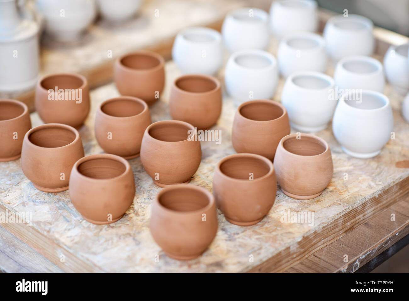 Close-up of clay pitchers before baking on the shelves at the pottery Stock Photo