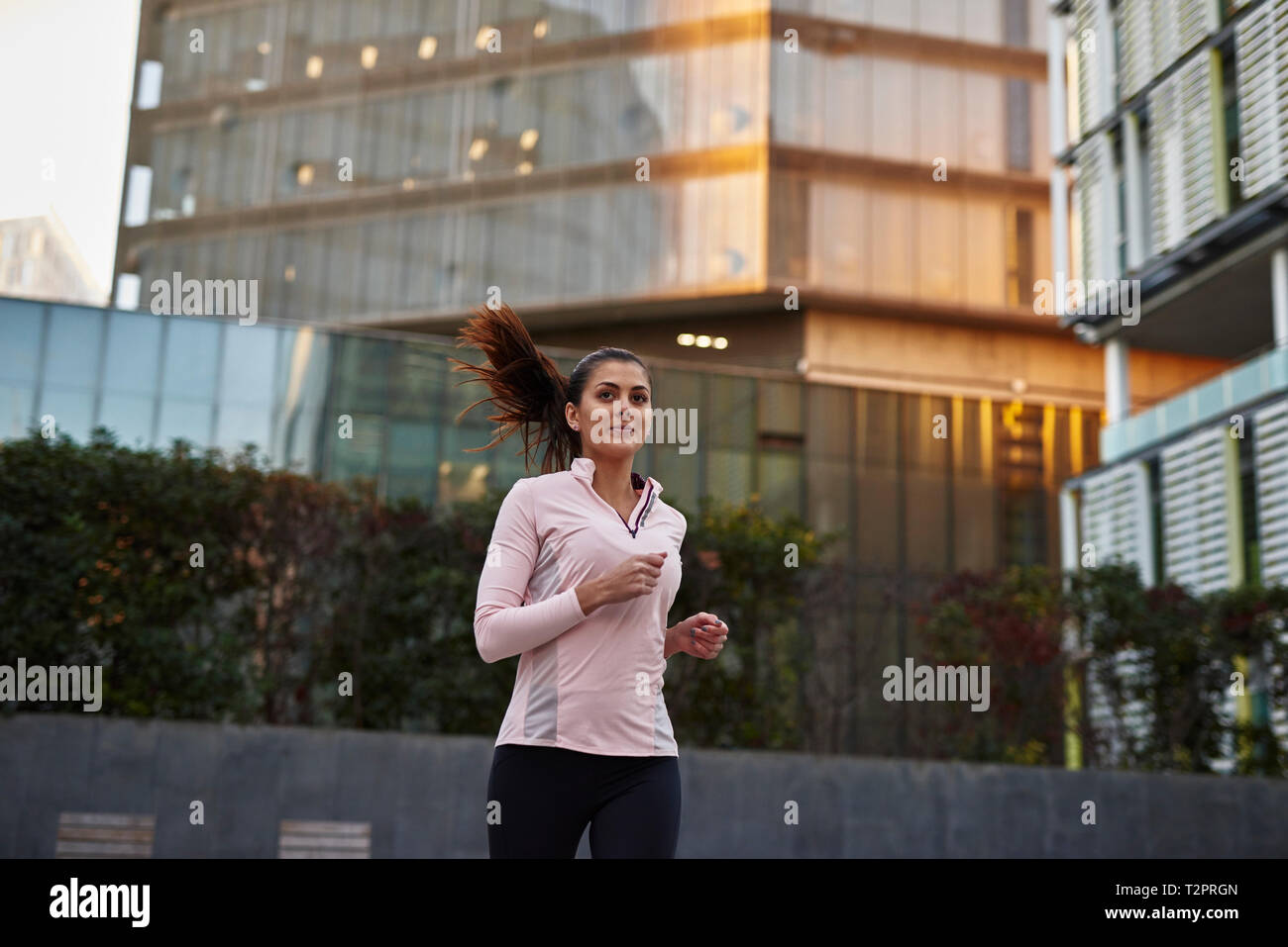 Woman jogging on sidewalk, Barcelona, Catalonia, Spain Stock Photo