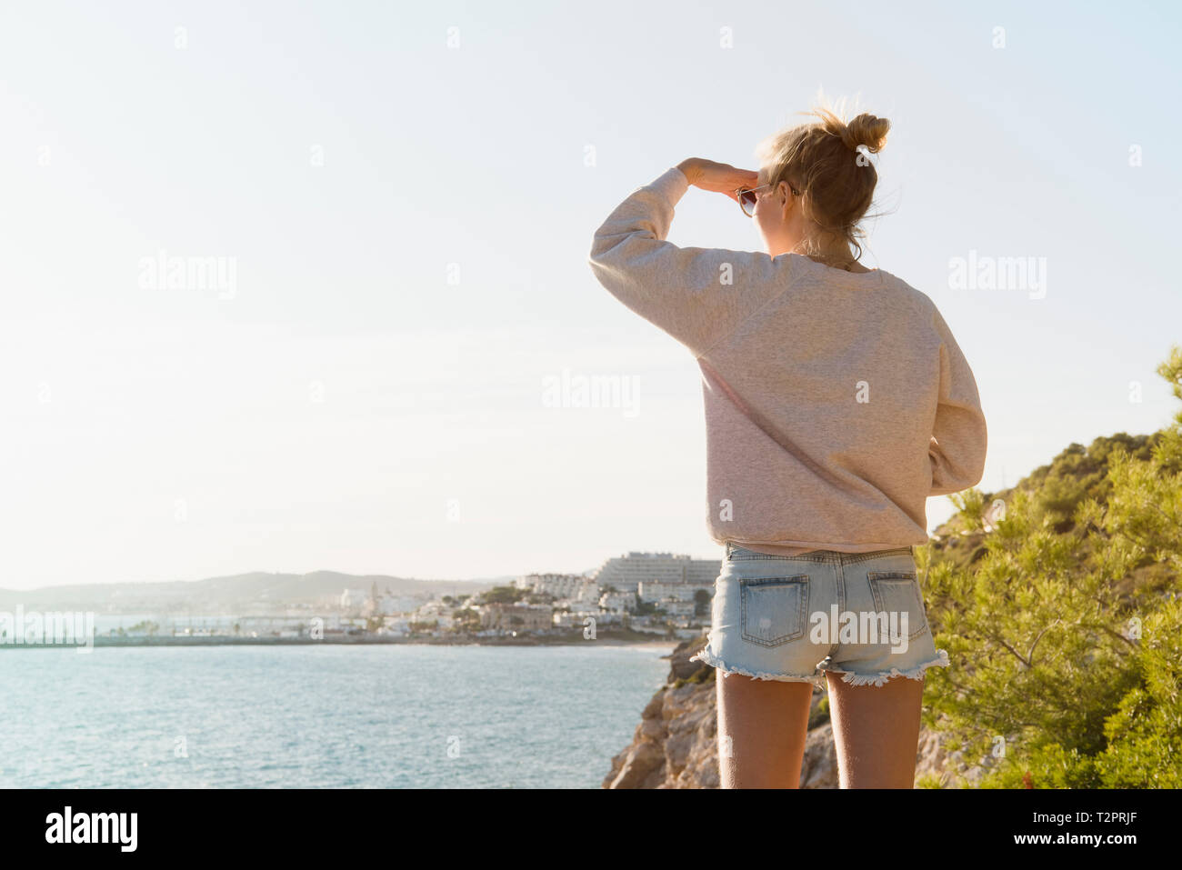 Woman enjoying view of sea, Sitges, Catalonia, Spain Stock Photo