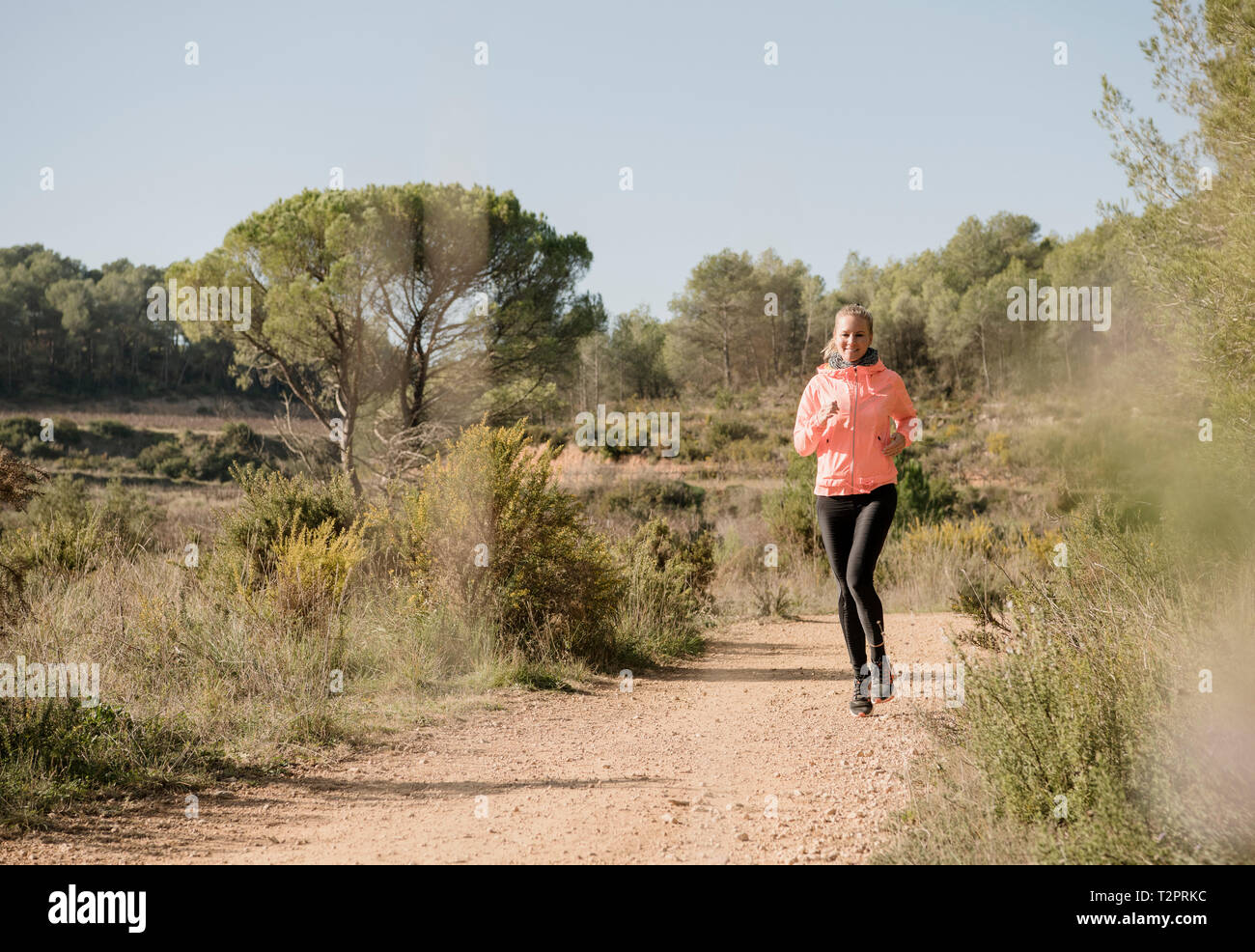 Woman jogging on dirt track, Olivella, Catalonia, Spain Stock Photo