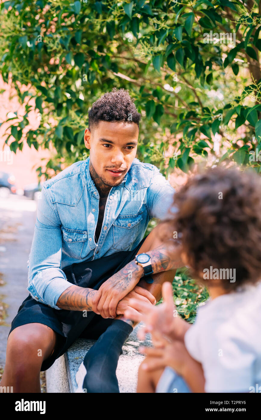 Father and son talking in park Stock Photo