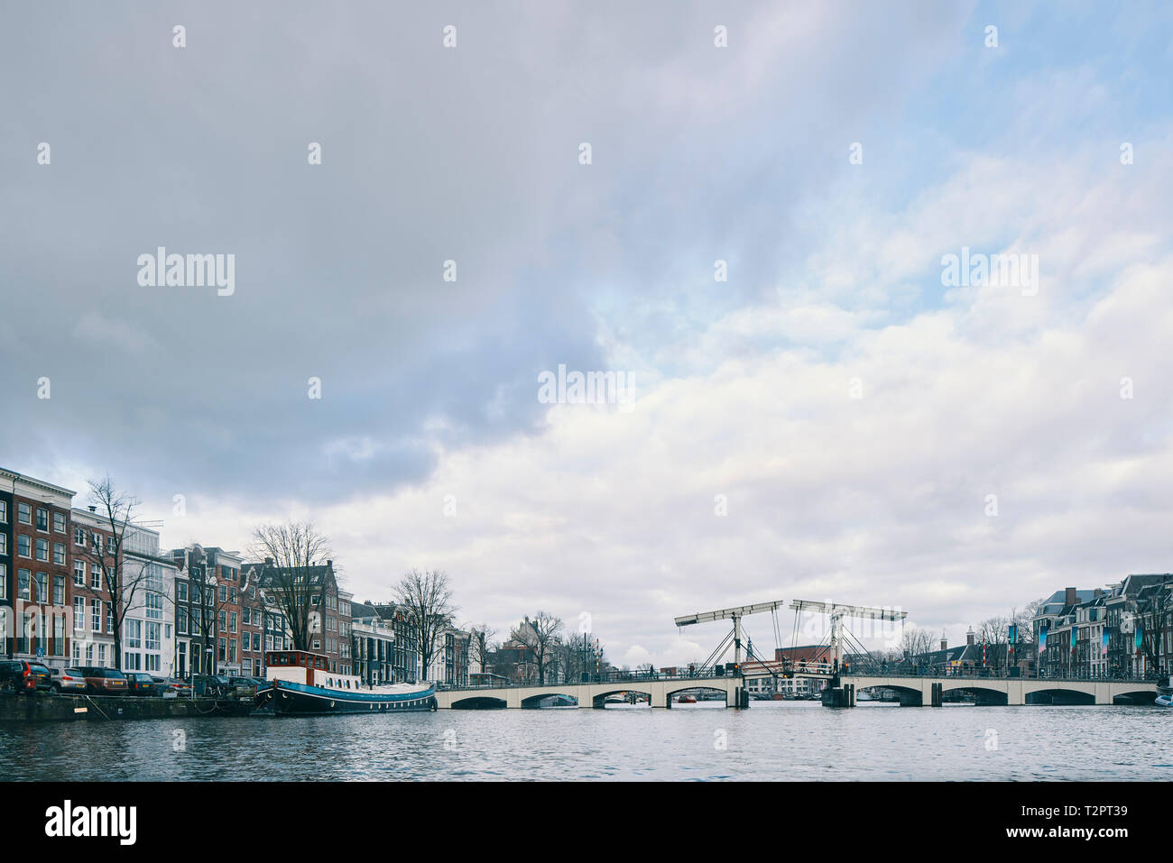Skinny Bridge, multistorey office and residential buildings along canal, Amsterdam, Noord-Holland, Netherlands Stock Photo