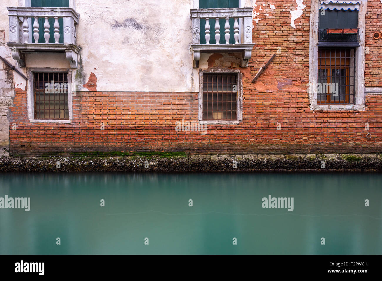 Canal in Venice with traditional old houses, Italy Stock Photo - Alamy