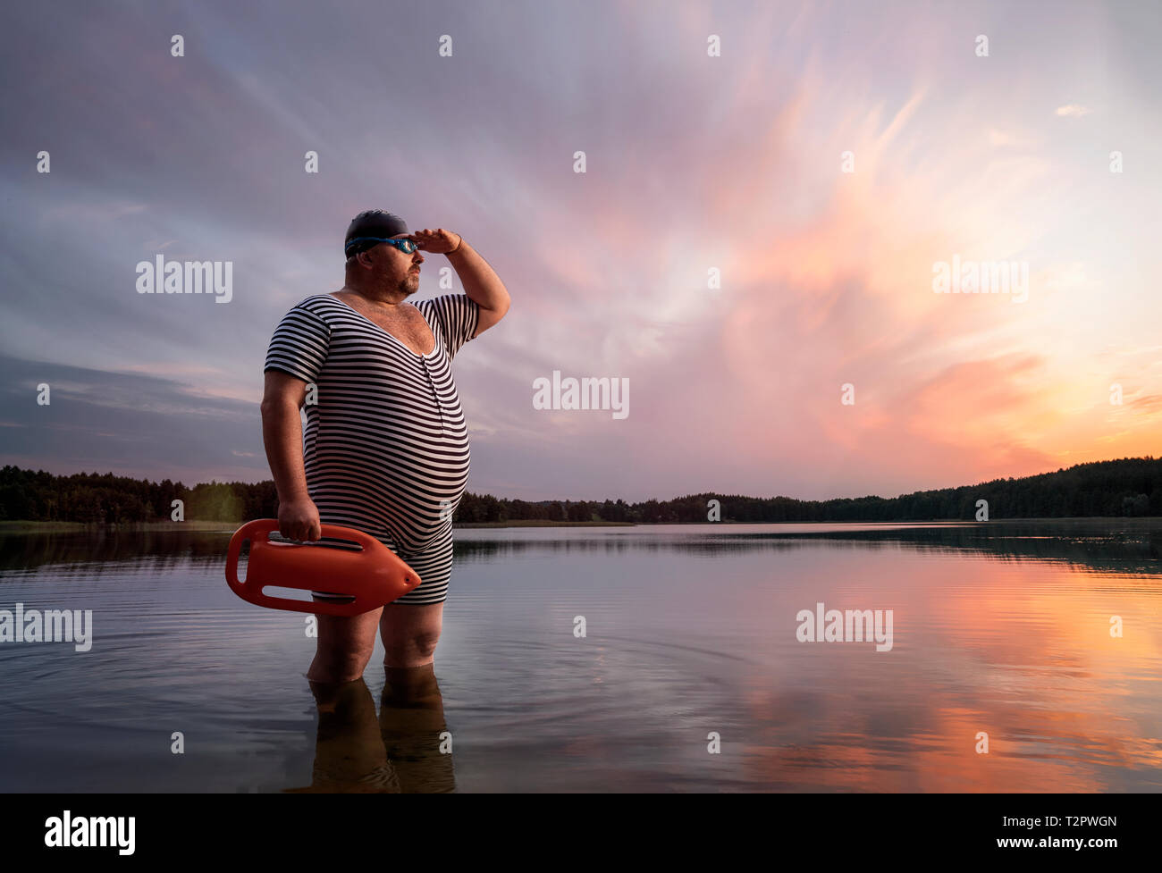 Funny retro lifeguard standing in the water and looking away with copy space Stock Photo
